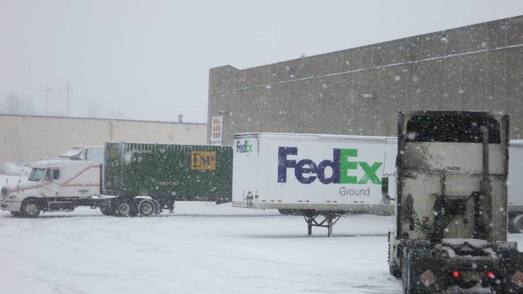 UPS and FedEx trailers in snow