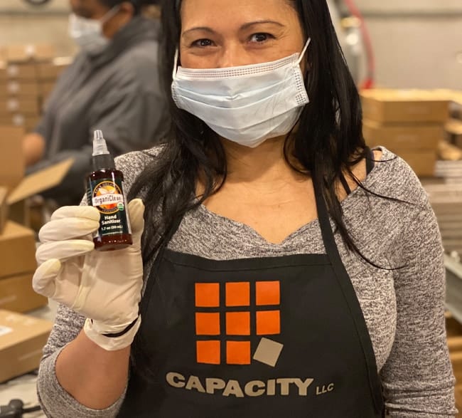 Capacity employee with PPE and Kai's hand sanitizer to New York