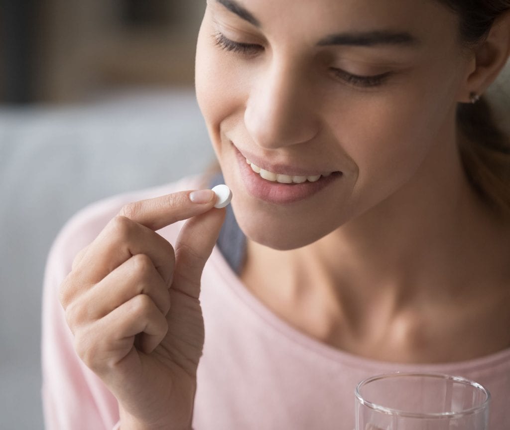 OTC pharma fulfillment - woman taking over-the-counter medicine
